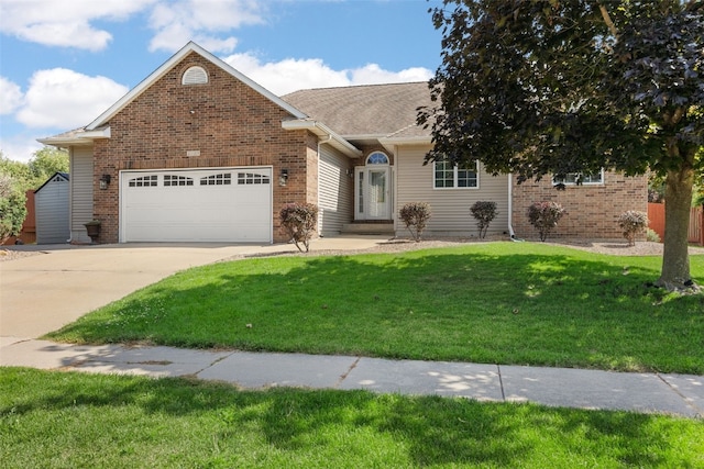1125 Saint Andrews Dr, North Liberty, IA 52317 - view of front of property featuring a garage, brick siding, and driveway