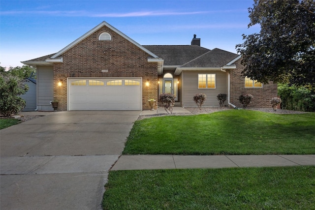 1125 Saint Andrews Dr, North Liberty, IA 52317 - traditional home with driveway, a chimney, an attached garage, a front lawn, and brick siding