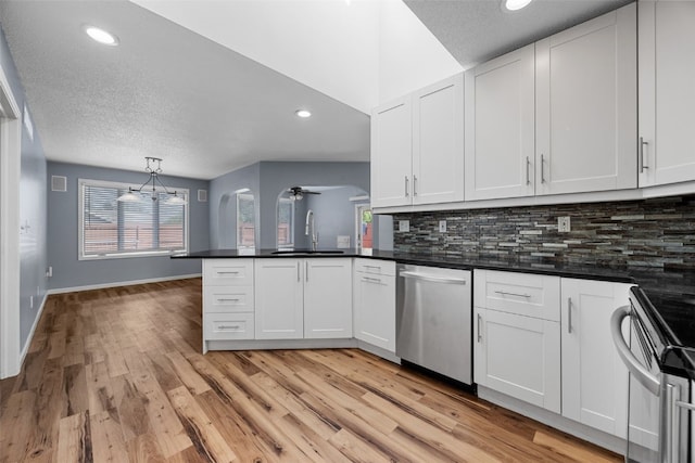 1125 Saint Andrews Dr, North Liberty, IA 52317 - kitchen with dishwasher, electric range, light wood-type flooring, a peninsula, and backsplash