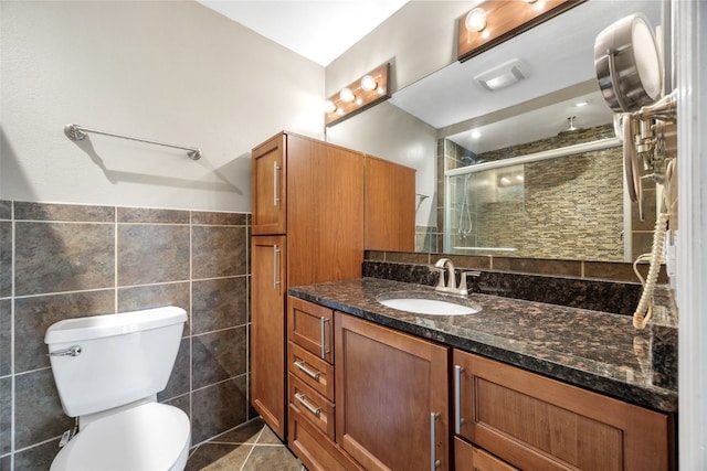 1125 Saint Andrews Dr, North Liberty, IA 52317 - bathroom with vanity, tile walls, a stall shower, and tile patterned flooring