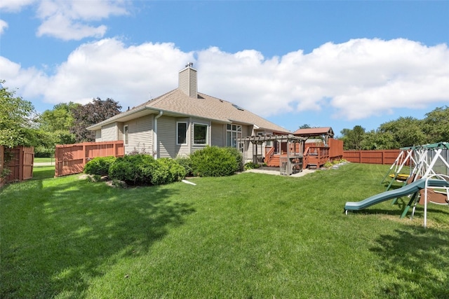 1125 Saint Andrews Dr, North Liberty, IA 52317 - back of house with a playground and a chimney