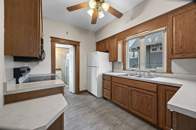 214 15th St NW, Cedar Rapids, IA 52405 - kitchen with freestanding refrigerator, electric range, ceiling fan, and light countertops