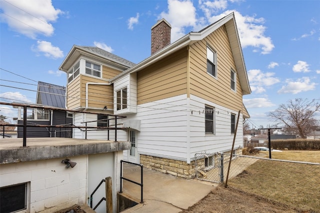 214 15th St NW, Cedar Rapids, IA 52405 - view of side of home with a chimney