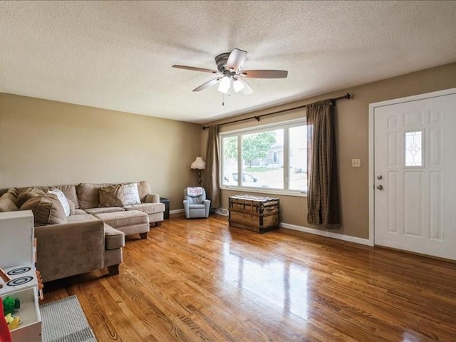 1175 F Ave, Marion, IA 52302 - living area with wood finished floors, ceiling fan, and a textured ceiling