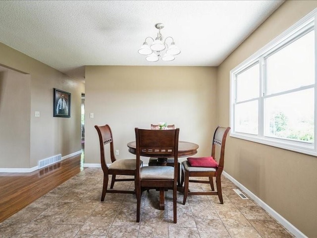1175 F Ave, Marion, IA 52302 - dining room featuring a chandelier and baseboards