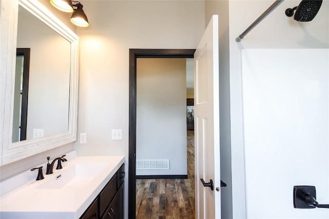 1600 Heartland St, Fairfax, IA 52228 - bathroom with vanity and wood finished floors