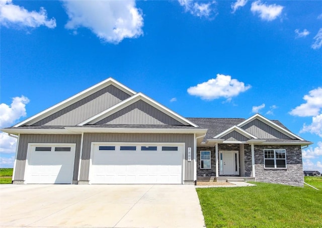 1600 Heartland St, Fairfax, IA 52228 - craftsman house with concrete driveway, a front lawn, an attached garage, and stone siding