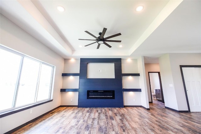 1600 Heartland St, Fairfax, IA 52228 - unfurnished living room with ceiling fan, wood finished floors, recessed lighting, a fireplace, and a raised ceiling