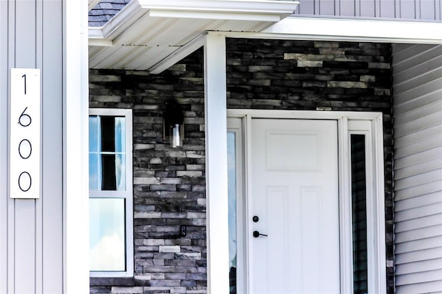 1600 Heartland St, Fairfax, IA 52228 - view of exterior entry featuring board and batten siding and stone siding