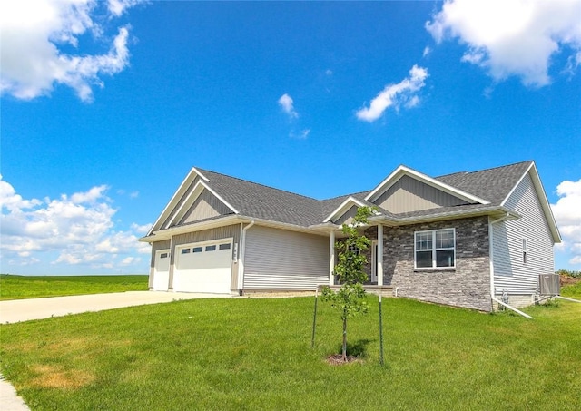 1600 Heartland St, Fairfax, IA 52228 - view of front of house featuring a garage, driveway, board and batten siding, and a front lawn