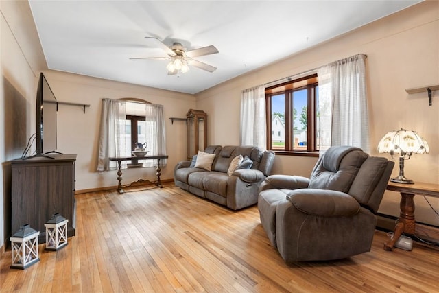 2469 1st St SW, Cedar Rapids, IA 52404 - living area featuring a ceiling fan and light wood-style floors