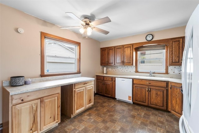 2469 1st St SW, Cedar Rapids, IA 52404 - kitchen with white appliances, ceiling fan, decorative backsplash, and light countertops