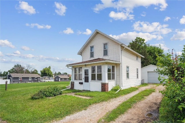 409 Railroad St, Fairfax, IA 52228 - view of front of home with dirt driveway, an outbuilding, a detached garage, and a front lawn