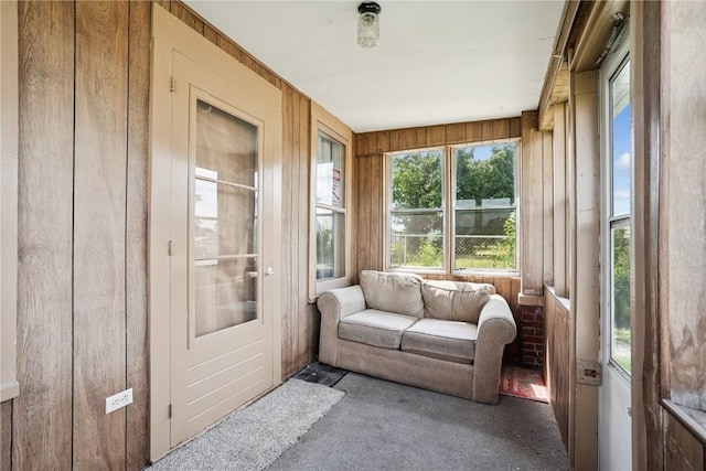 409 Railroad St, Fairfax, IA 52228 - sunroom / solarium with carpet flooring and wood walls