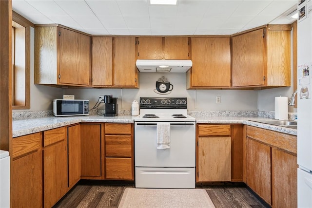409 Railroad St, Fairfax, IA 52228 - kitchen featuring black microwave, electric range, dark wood finished floors, light countertops, and under cabinet range hood