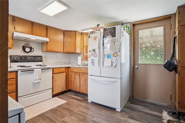 409 Railroad St, Fairfax, IA 52228 - kitchen with white appliances, under cabinet range hood, light countertops, and dark wood-type flooring