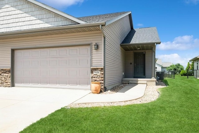 5616 Dostal Dr SW, Cedar Rapids, IA 52404 - view of side of property with an attached garage, driveway, a shingled roof, and stone siding