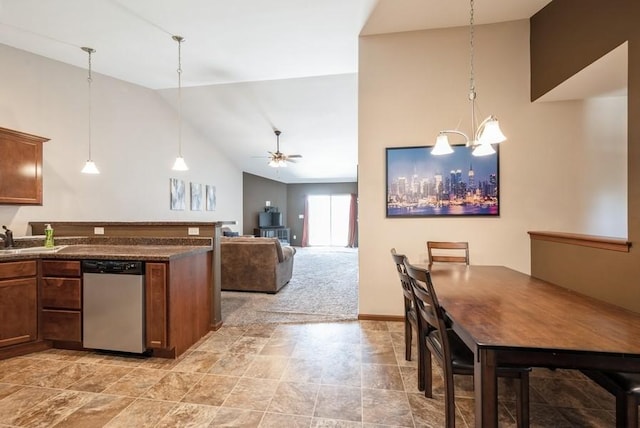 5616 Dostal Dr SW, Cedar Rapids, IA 52404 - kitchen with stainless steel dishwasher, dark countertops, decorative light fixtures, high vaulted ceiling, and a peninsula