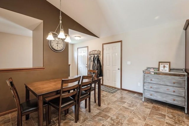 5616 Dostal Dr SW, Cedar Rapids, IA 52404 - dining space featuring a chandelier, stone finish floors, and vaulted ceiling