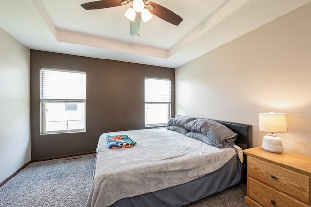 5616 Dostal Dr SW, Cedar Rapids, IA 52404 - carpeted bedroom featuring a raised ceiling and a ceiling fan