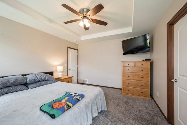5616 Dostal Dr SW, Cedar Rapids, IA 52404 - carpeted bedroom featuring a tray ceiling and ceiling fan