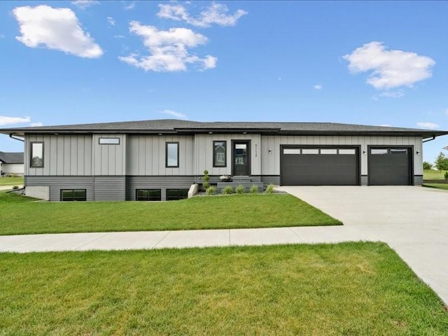 5112 Scenic View Ct SW, Cedar Rapids, IA 52404 - view of front facade with concrete driveway, a front lawn, an attached garage, and board and batten siding