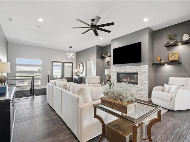 5112 Scenic View Ct SW, Cedar Rapids, IA 52404 - living area with dark wood-style floors, a ceiling fan, a stone fireplace, and recessed lighting