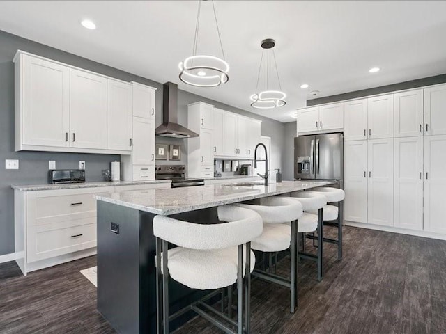 5112 Scenic View Ct SW, Cedar Rapids, IA 52404 - kitchen featuring wall chimney exhaust hood, appliances with stainless steel finishes, dark wood finished floors, white cabinetry, and recessed lighting