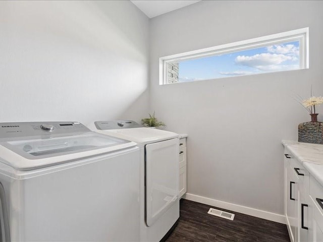 5112 Scenic View Ct SW, Cedar Rapids, IA 52404 - laundry area with washer and dryer, dark wood-style floors, and cabinet space