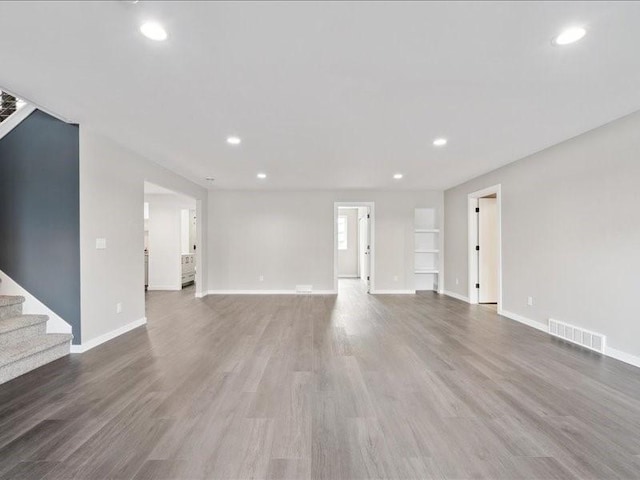 5112 Scenic View Ct SW, Cedar Rapids, IA 52404 - unfurnished living room featuring recessed lighting, wood finished floors, and stairs