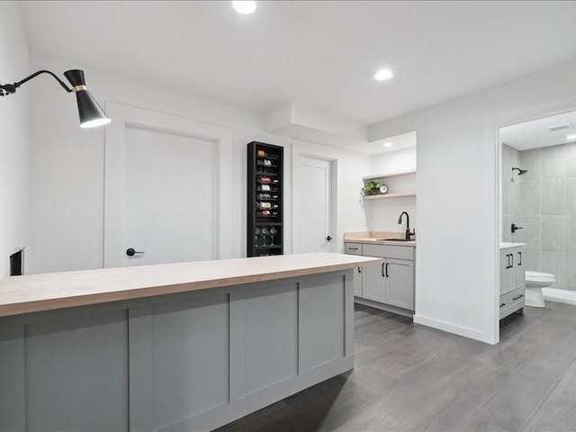 5112 Scenic View Ct SW, Cedar Rapids, IA 52404 - indoor bar with wine cooler, wood finished floors, and recessed lighting