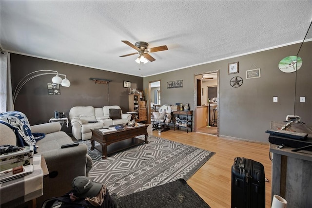 200 Drexel Dr SW, Cedar Rapids, IA 52404 - living room featuring a ceiling fan, ornamental molding, a textured ceiling, and wood finished floors