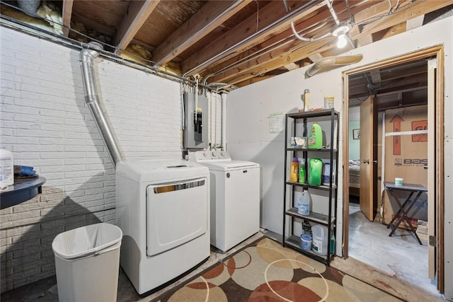 200 Drexel Dr SW, Cedar Rapids, IA 52404 - washroom featuring electric panel, separate washer and dryer, and brick wall