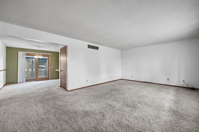 805 W 17th St, Vinton, IA 52349 - carpeted spare room featuring a chandelier and a textured ceiling