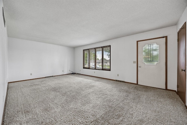 805 W 17th St, Vinton, IA 52349 - carpeted empty room with a textured ceiling
