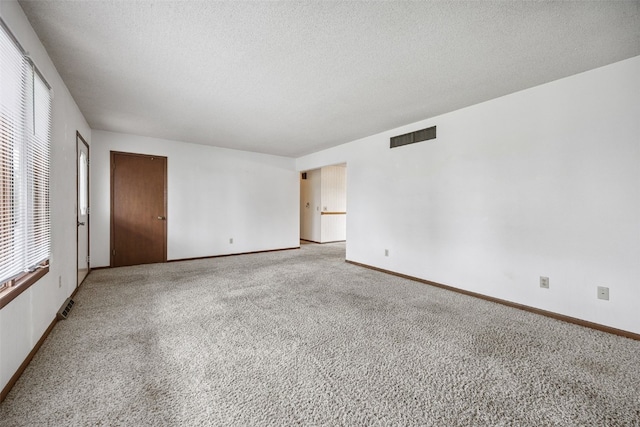 805 W 17th St, Vinton, IA 52349 - empty room with carpet flooring and a textured ceiling