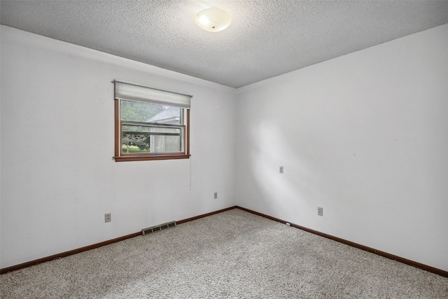 805 W 17th St, Vinton, IA 52349 - carpeted empty room with a textured ceiling and baseboards