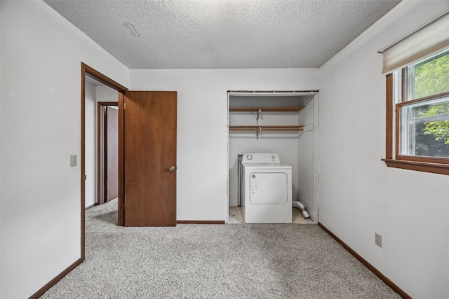 805 W 17th St, Vinton, IA 52349 - washroom with washer / dryer, a textured ceiling, and carpet flooring
