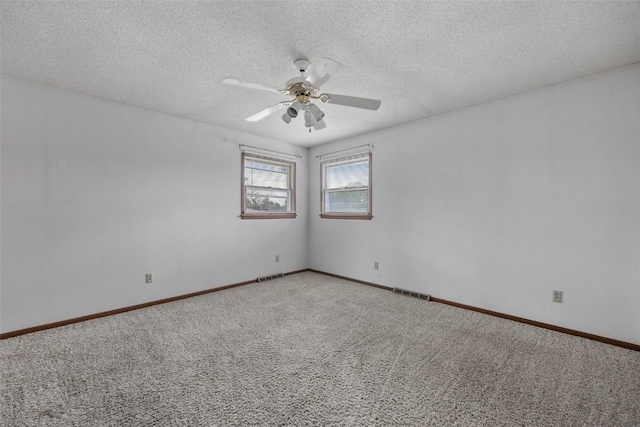 805 W 17th St, Vinton, IA 52349 - carpeted spare room with ceiling fan and a textured ceiling