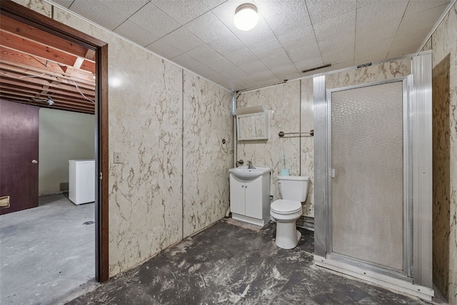 805 W 17th St, Vinton, IA 52349 - full bath featuring washer / dryer, unfinished concrete floors, a shower stall, and vanity