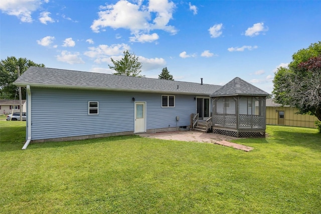 805 W 17th St, Vinton, IA 52349 - rear view of house featuring a patio, a yard, and roof with shingles