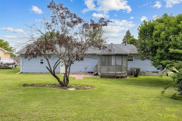 805 W 17th St, Vinton, IA 52349 - back of property featuring a sunroom, a lawn, and a shingled roof