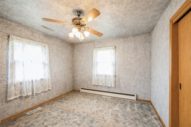 819 Valley St, Center Point, IA 52213 - spare room with a baseboard radiator, carpet floors, and a ceiling fan