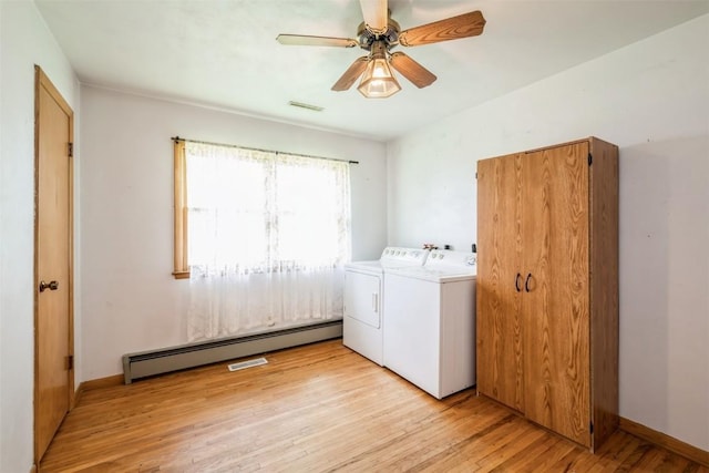 819 Valley St, Center Point, IA 52213 - laundry room featuring washer and dryer, a baseboard heating unit, light wood-type flooring, and ceiling fan