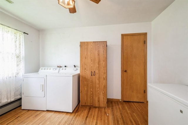 819 Valley St, Center Point, IA 52213 - laundry area featuring baseboard heating, separate washer and dryer, a ceiling fan, and wood finished floors