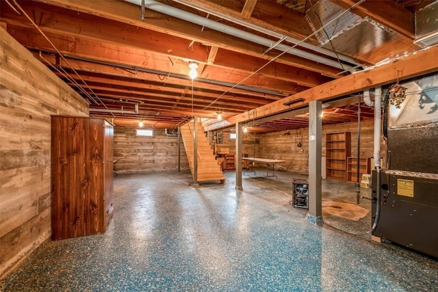 819 Valley St, Center Point, IA 52213 - unfinished basement featuring stairs, heating unit, and wooden walls