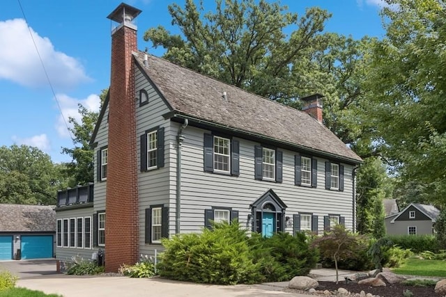 318 Ferson Ave, Iowa City, IA 52246 - colonial house featuring a chimney and driveway