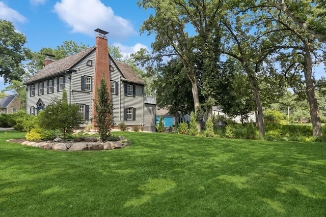 318 Ferson Ave, Iowa City, IA 52246 - view of side of property featuring a chimney and a lawn