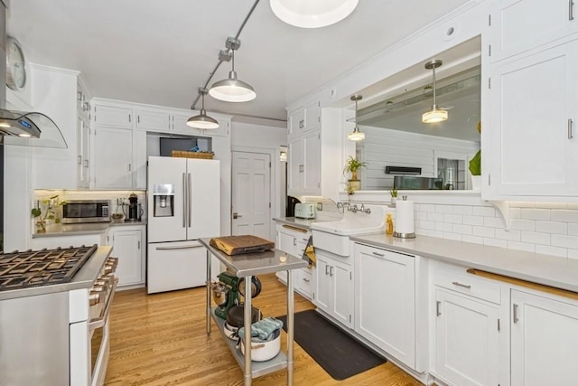 318 Ferson Ave, Iowa City, IA 52246 - kitchen with white appliances, tasteful backsplash, white cabinetry, and light wood finished floors