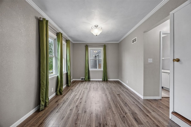2539 Vernon Ct SE, Cedar Rapids, IA 52403 - empty room with wood finished floors and crown molding